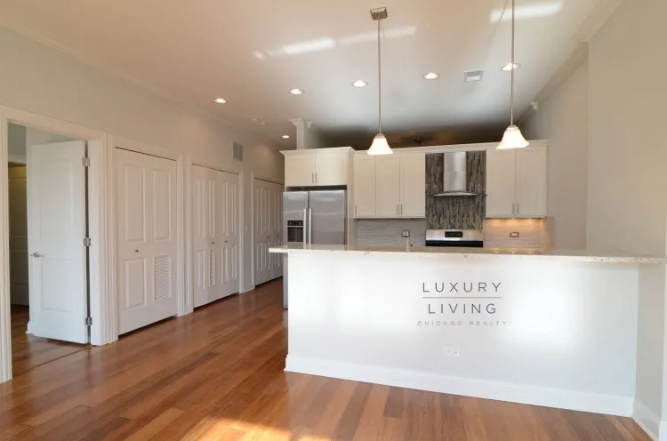 model kitchen and living room with wood floors at Huron Place Apartments