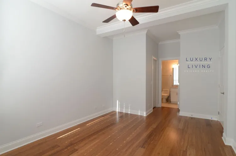 model kitchen and living room with wood floors at Huron Place Apartments