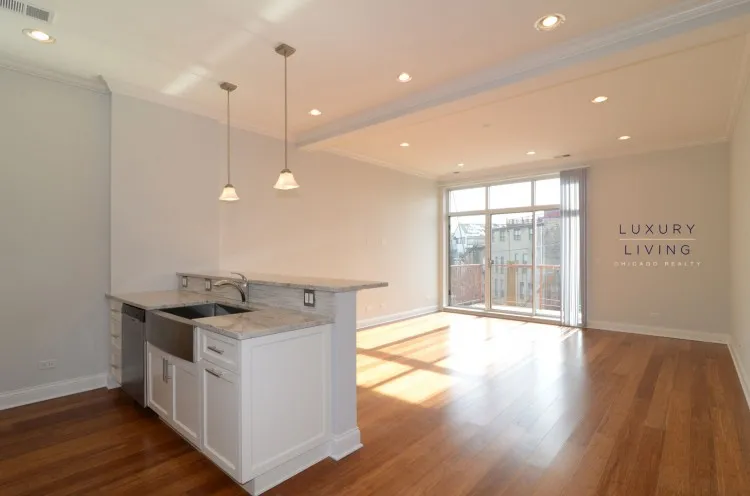 model kitchen and living room with wood floors at Huron Place Apartments