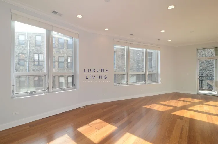 model kitchen and living room with wood floors at Huron Place Apartments