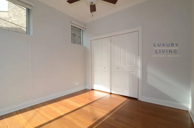 model kitchen and living room with wood floors at Huron Place Apartments