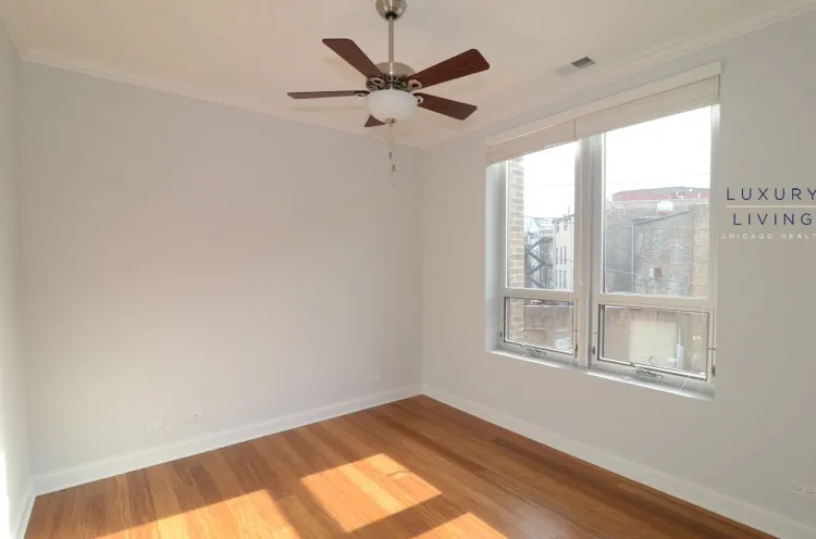 model kitchen and living room with wood floors at Huron Place Apartments