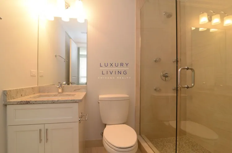model kitchen and living room with wood floors at Huron Place Apartments