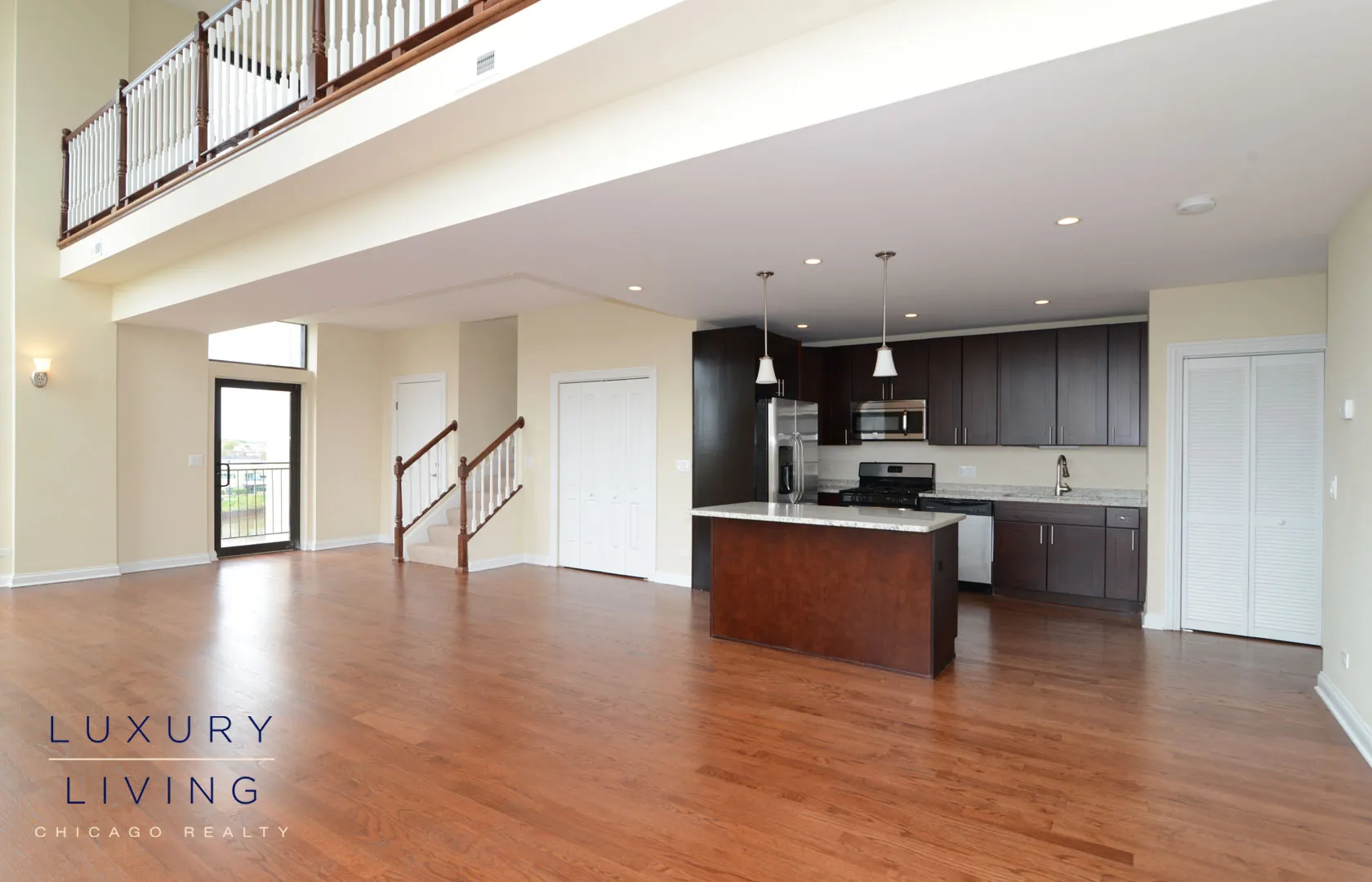 kitchen and island with wood floors at Riverview Terrace Apartments