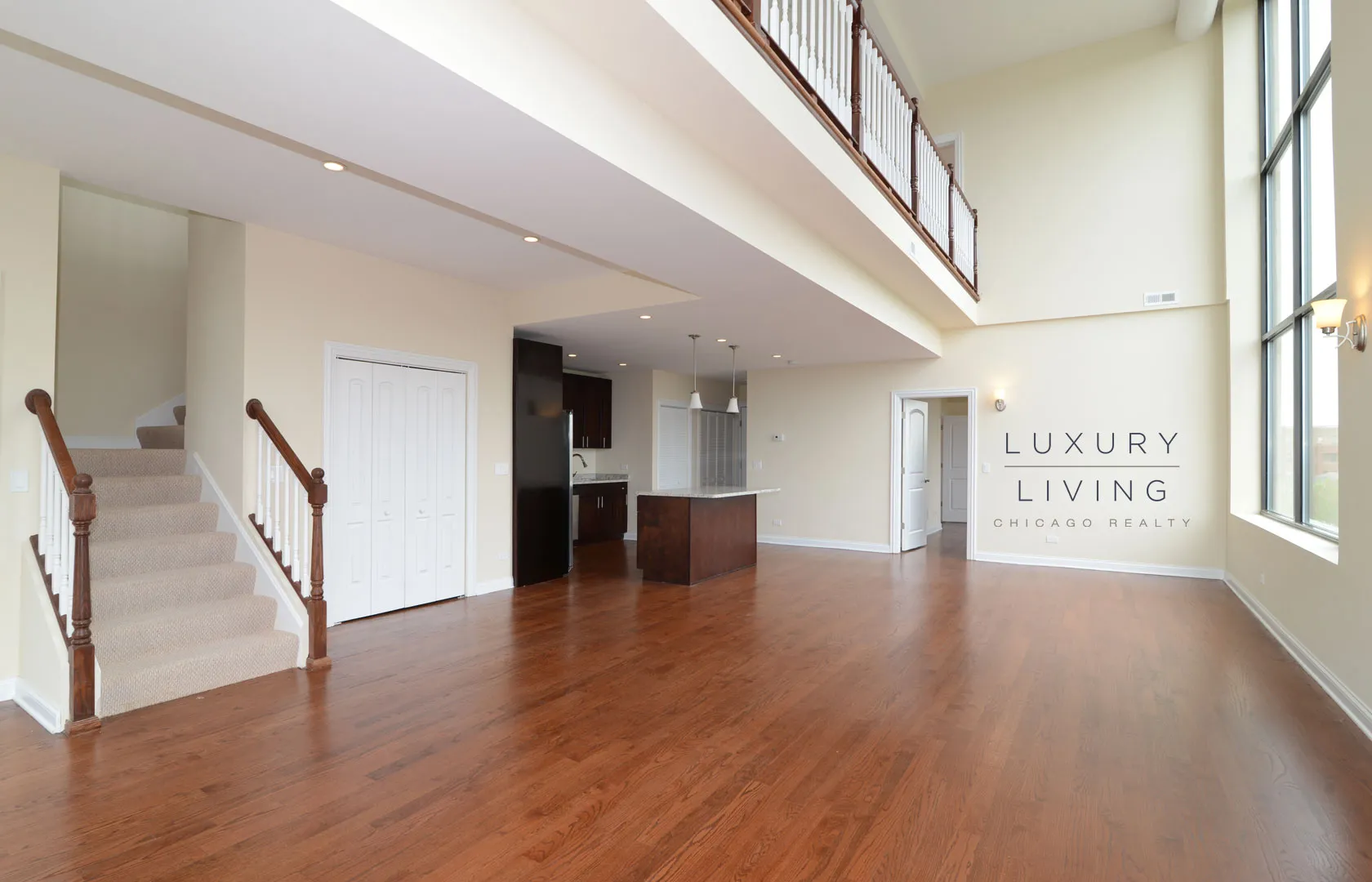 kitchen and island with wood floors at Riverview Terrace Apartments