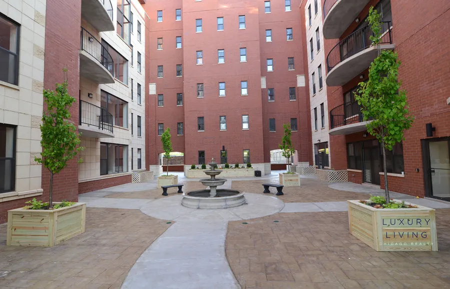 kitchen and island with wood floors at Riverview Terrace Apartments