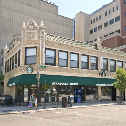 corner view of Reside 2525 Apartments with Starbucks on 1st floor