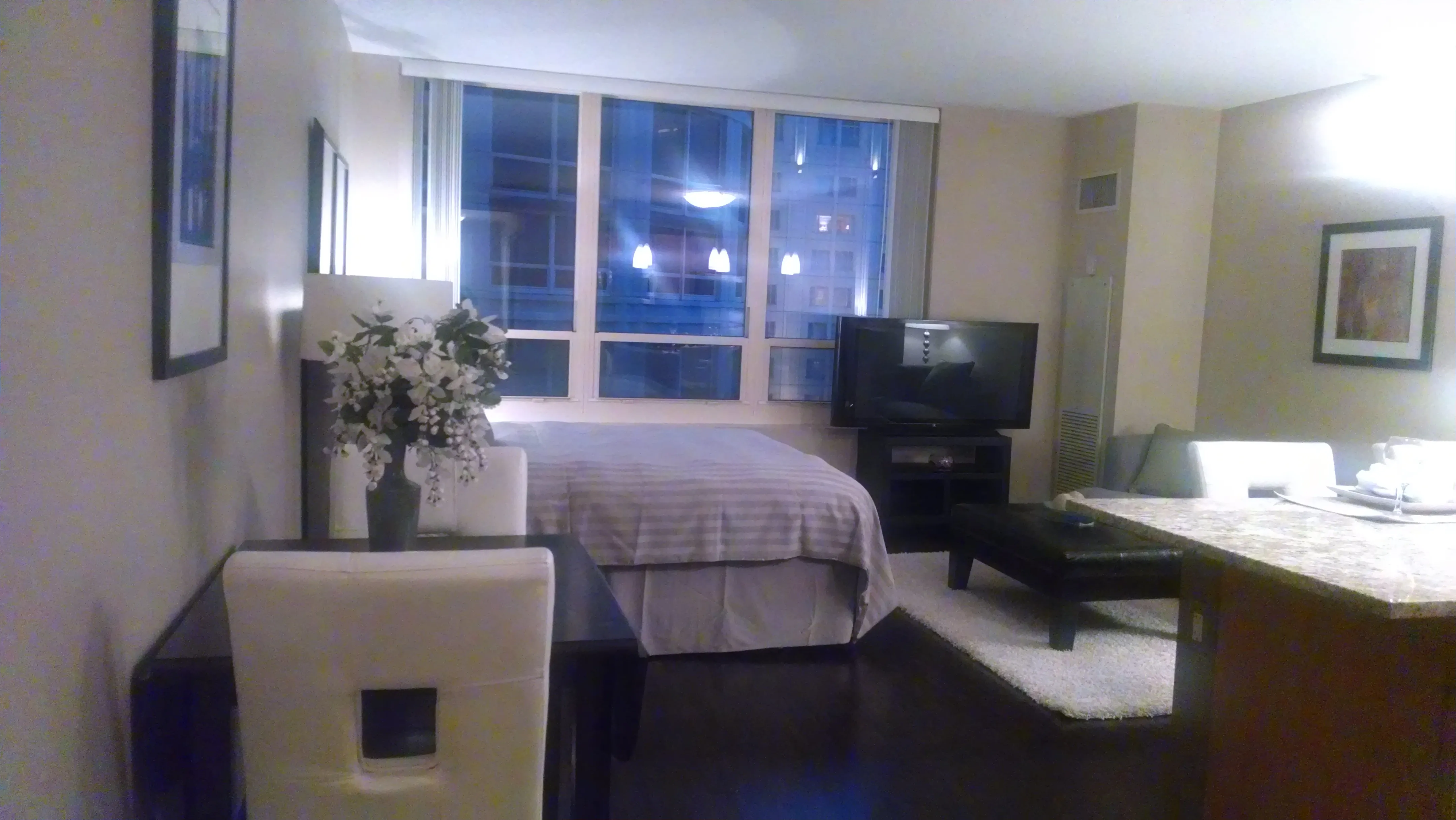 view looking up at The Bernardin Apartments with car traffic