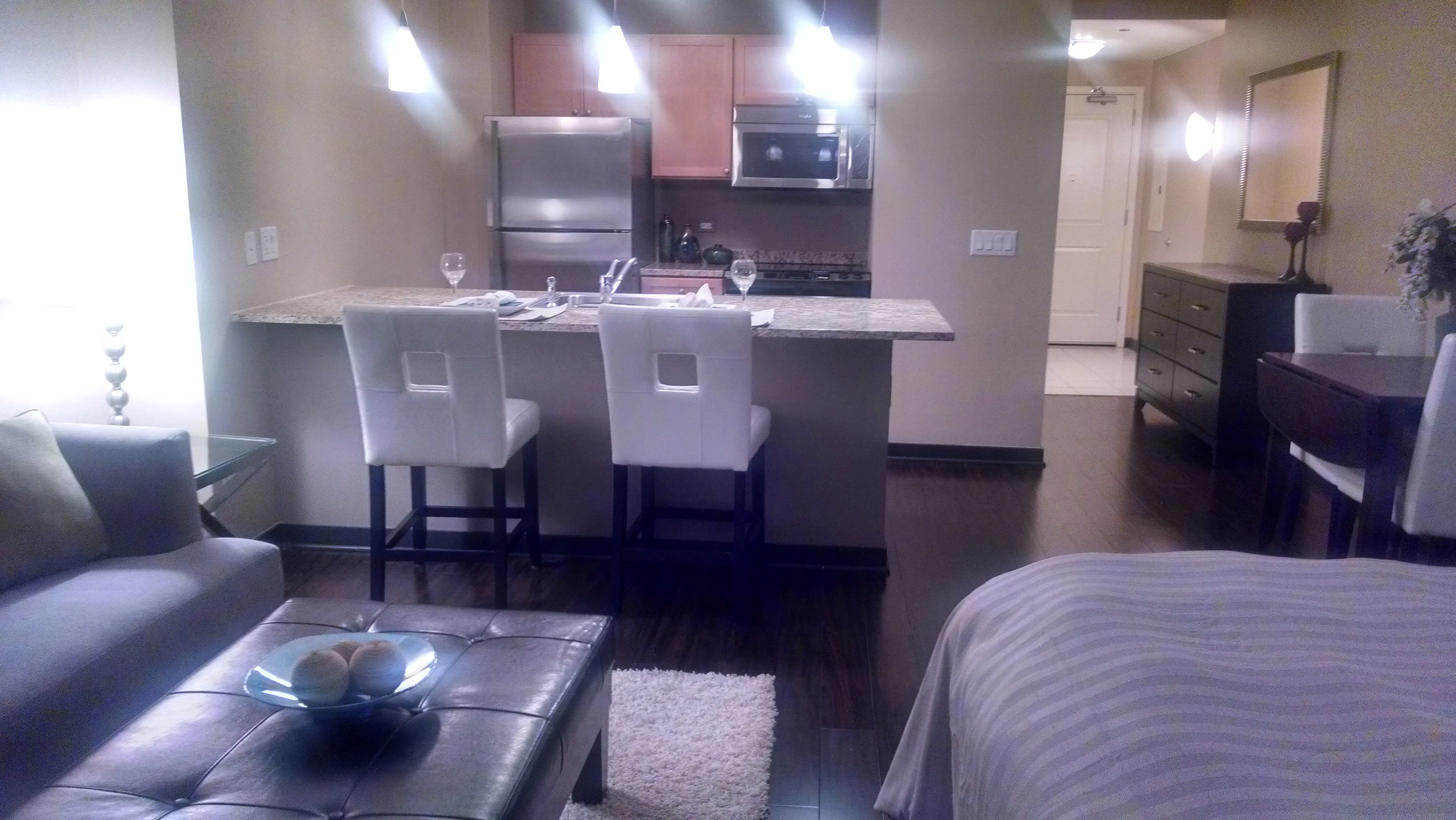 view looking up at The Bernardin Apartments with car traffic