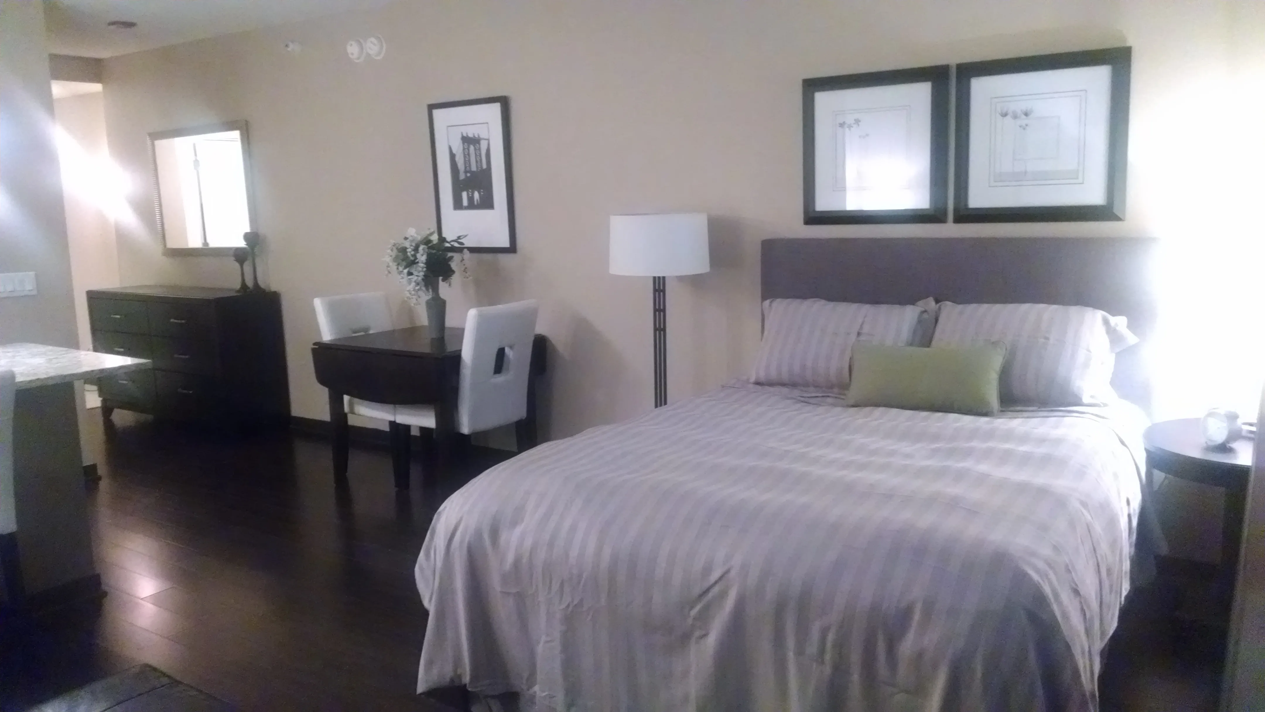 view looking up at The Bernardin Apartments with car traffic