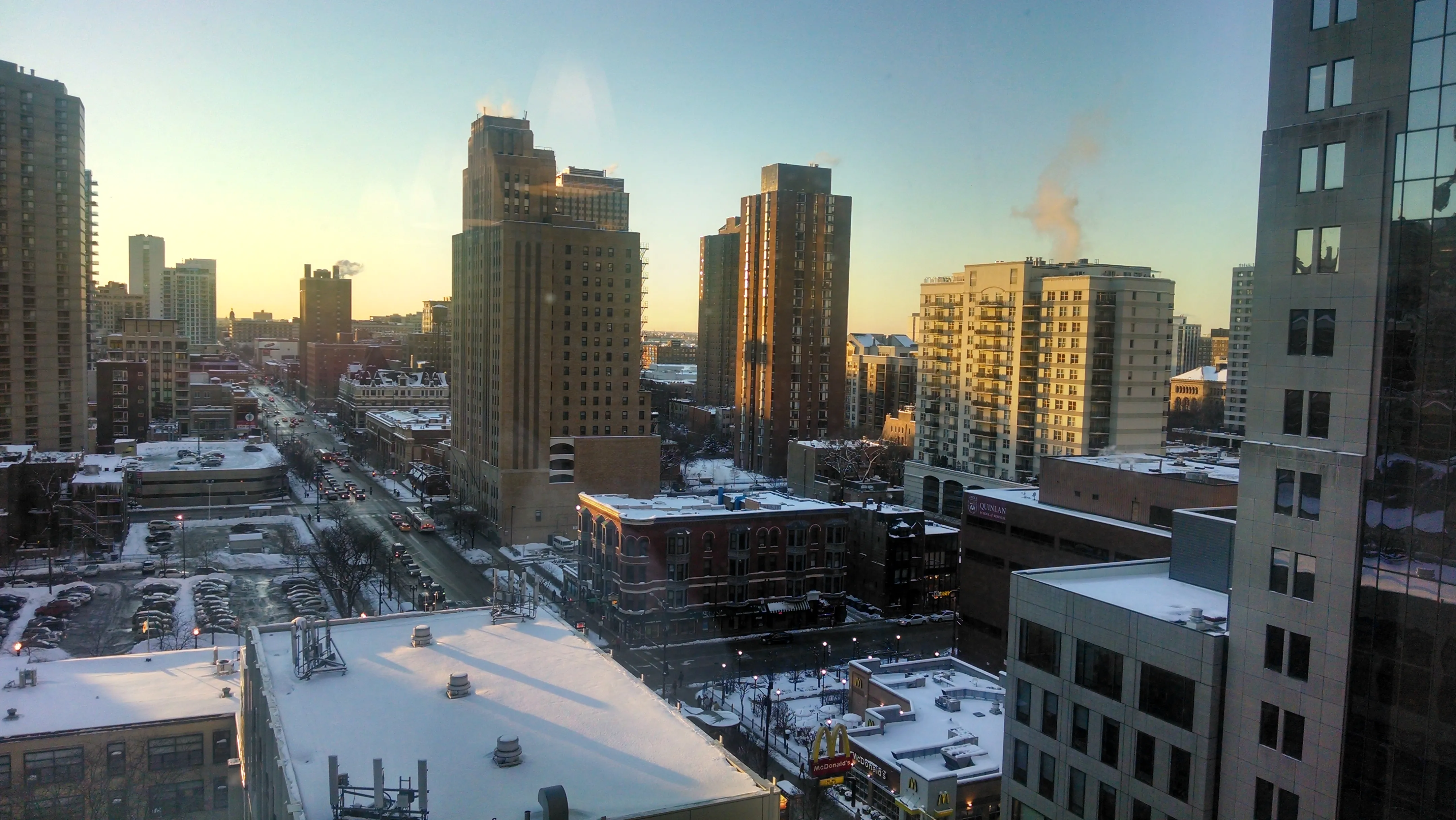 view looking up at The Bernardin Apartments with car traffic