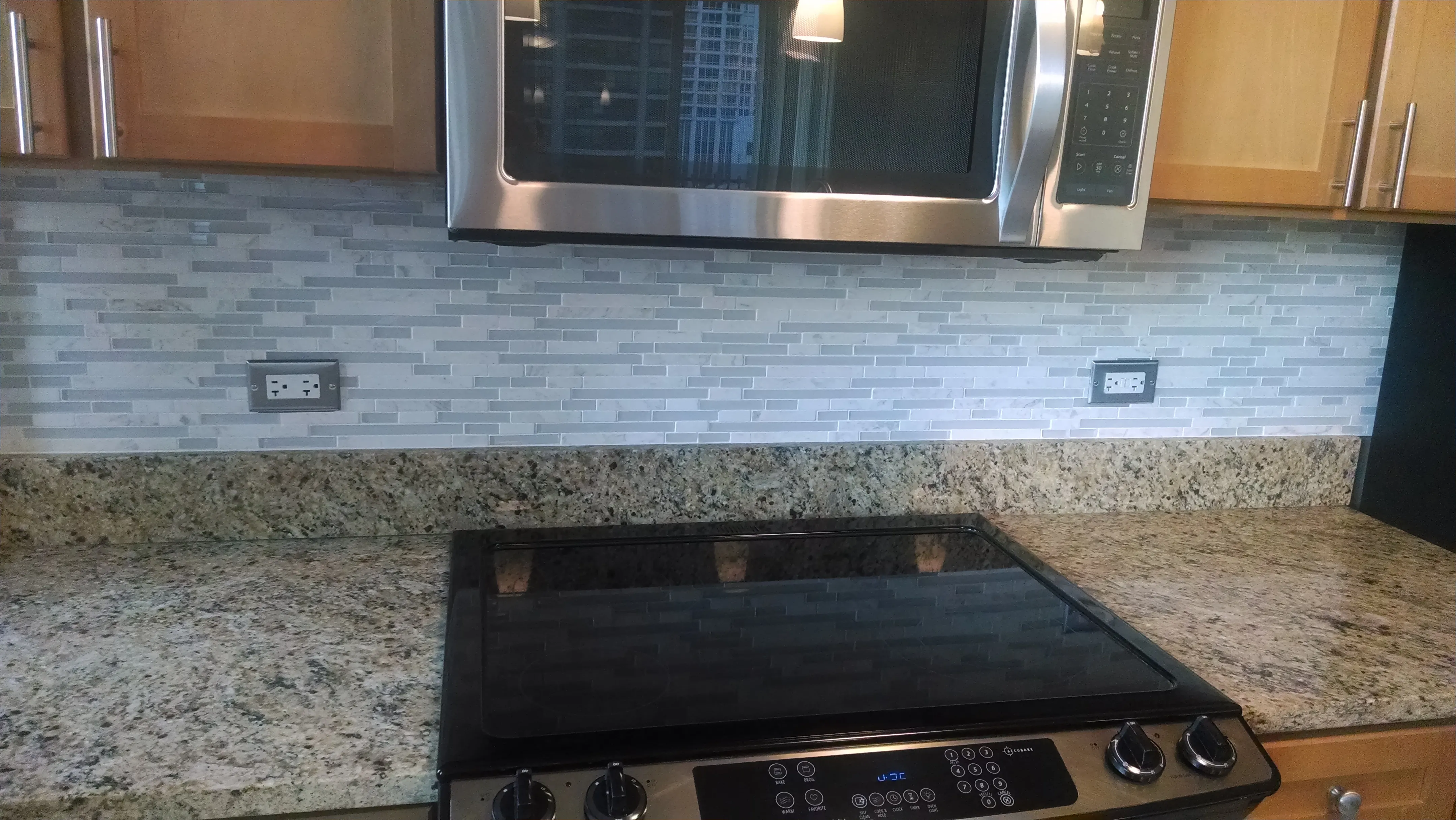 view looking up at The Bernardin Apartments with car traffic