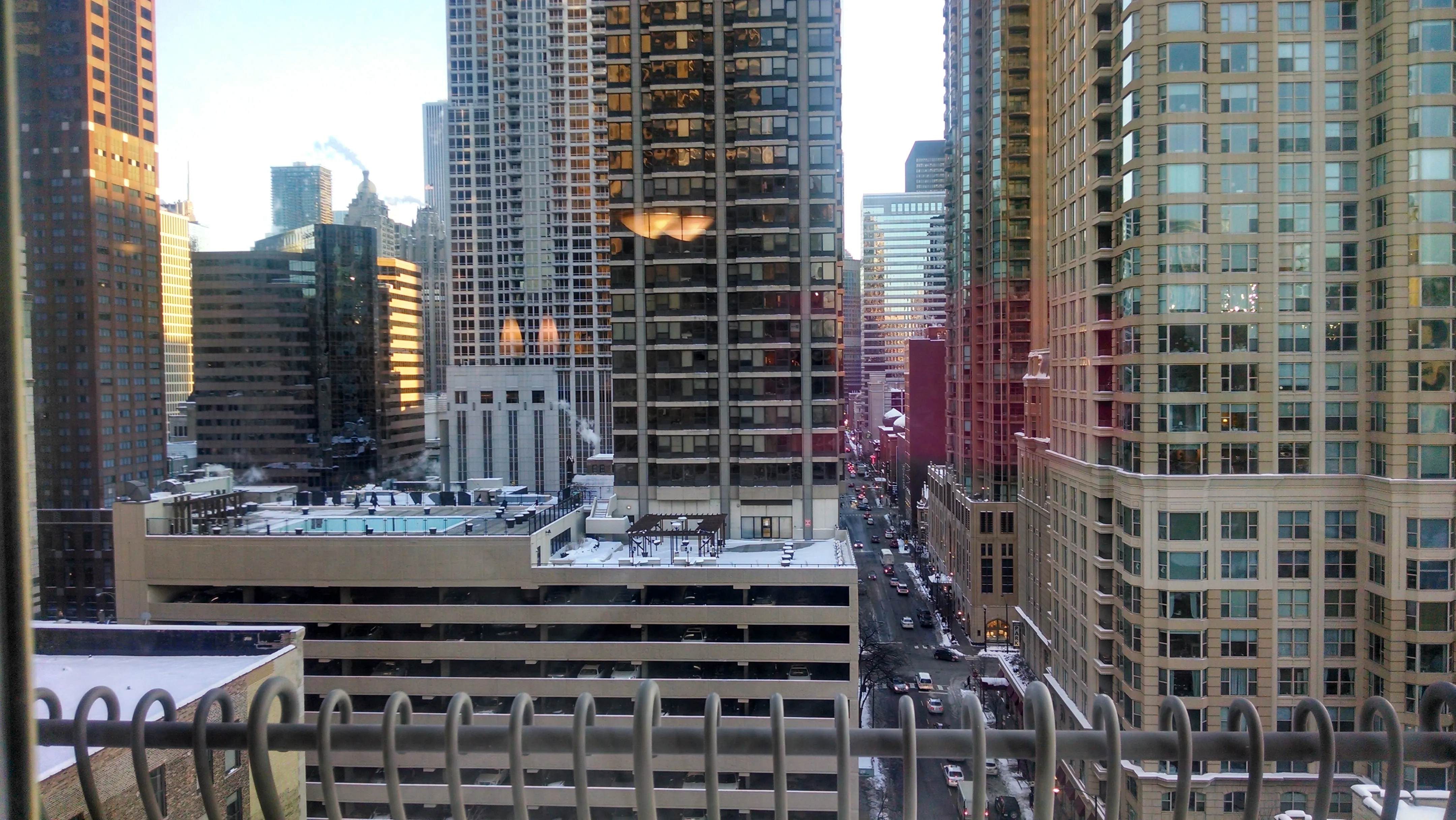 view looking up at The Bernardin Apartments with car traffic