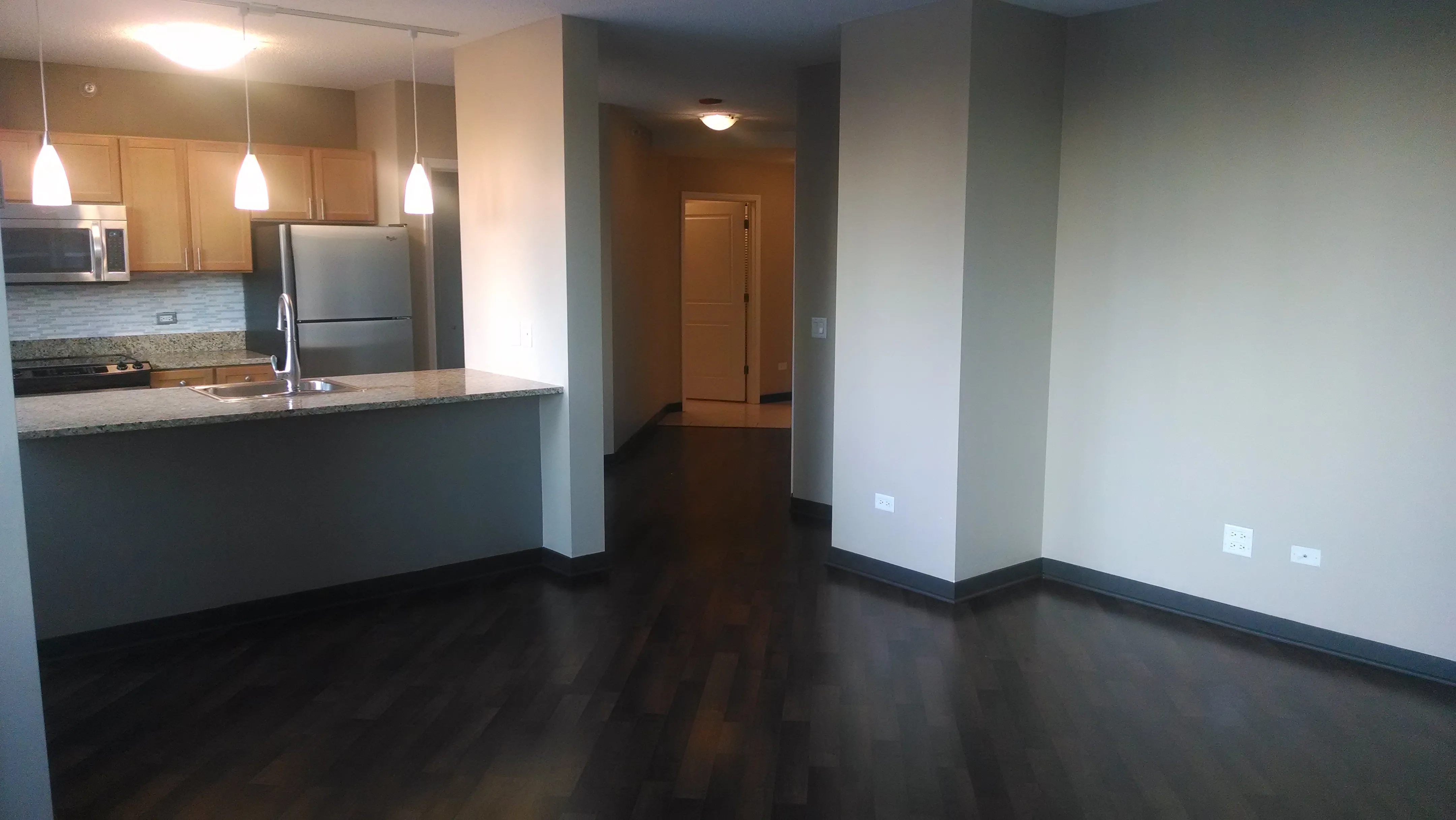 view looking up at The Bernardin Apartments with car traffic