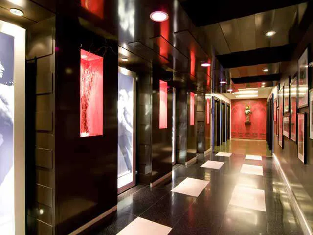 entrance to MDA City Club Apartments with red bench a flowers in pot