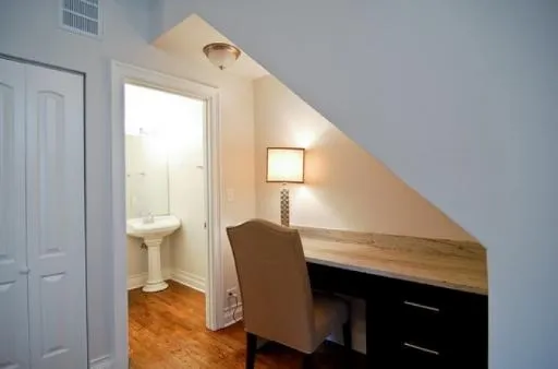 Half bath and desk under stairscase