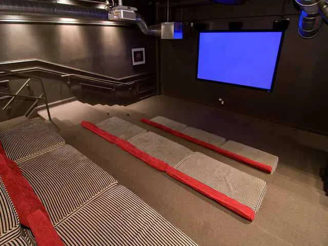 entrance to MDA City Club Apartments with red bench a flowers in pot