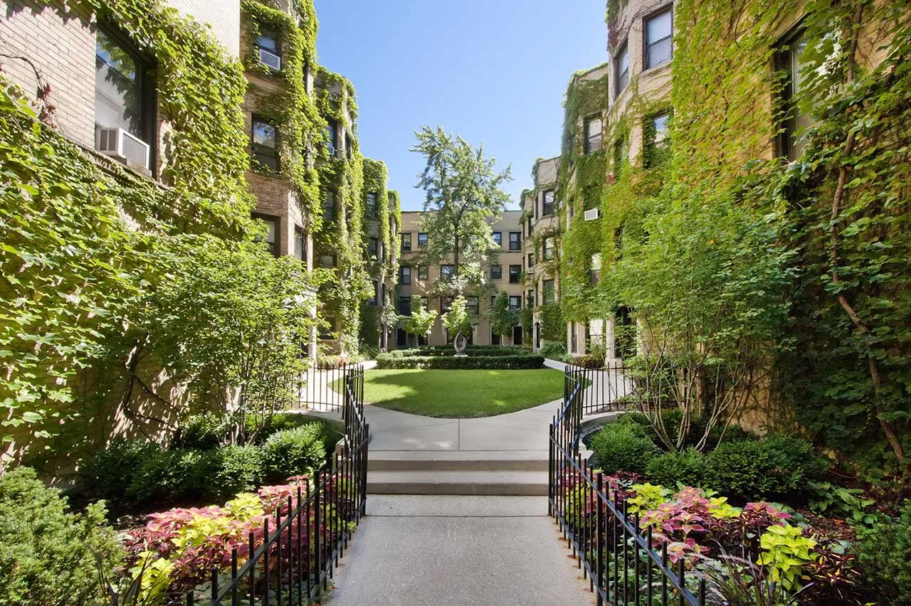 courtyard with flowers and ivy on brick at Reside at 849 Apartments