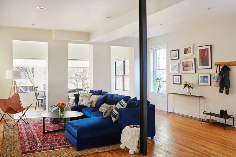 living room with blue couch at Common Briar Apartments in Lakeview Chicago