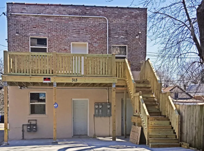 apartment building with wooden balcony in East Garfield Park of Chicago, IL