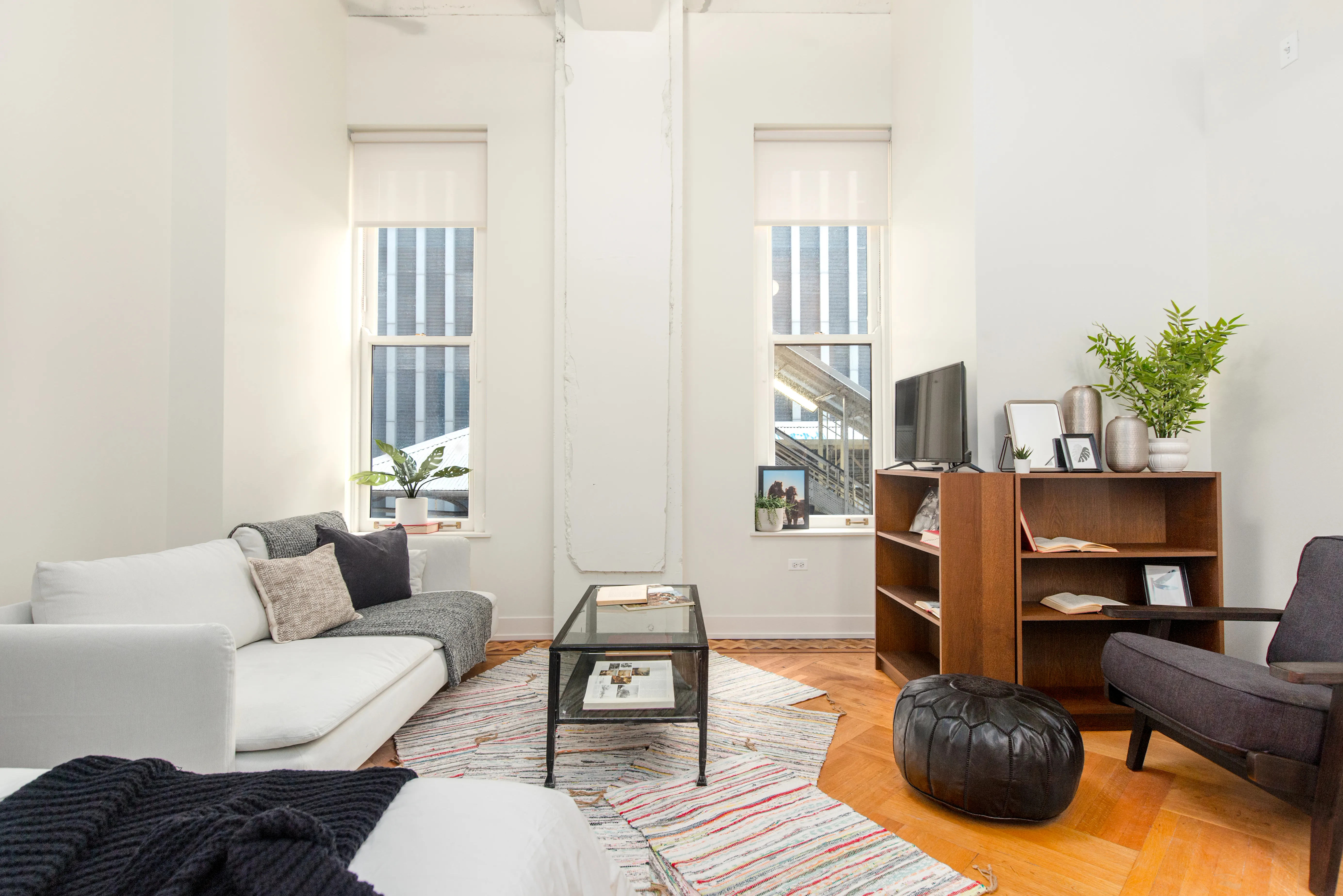 living room with grey sofa and hardwood floors in Chicago Loop apartment