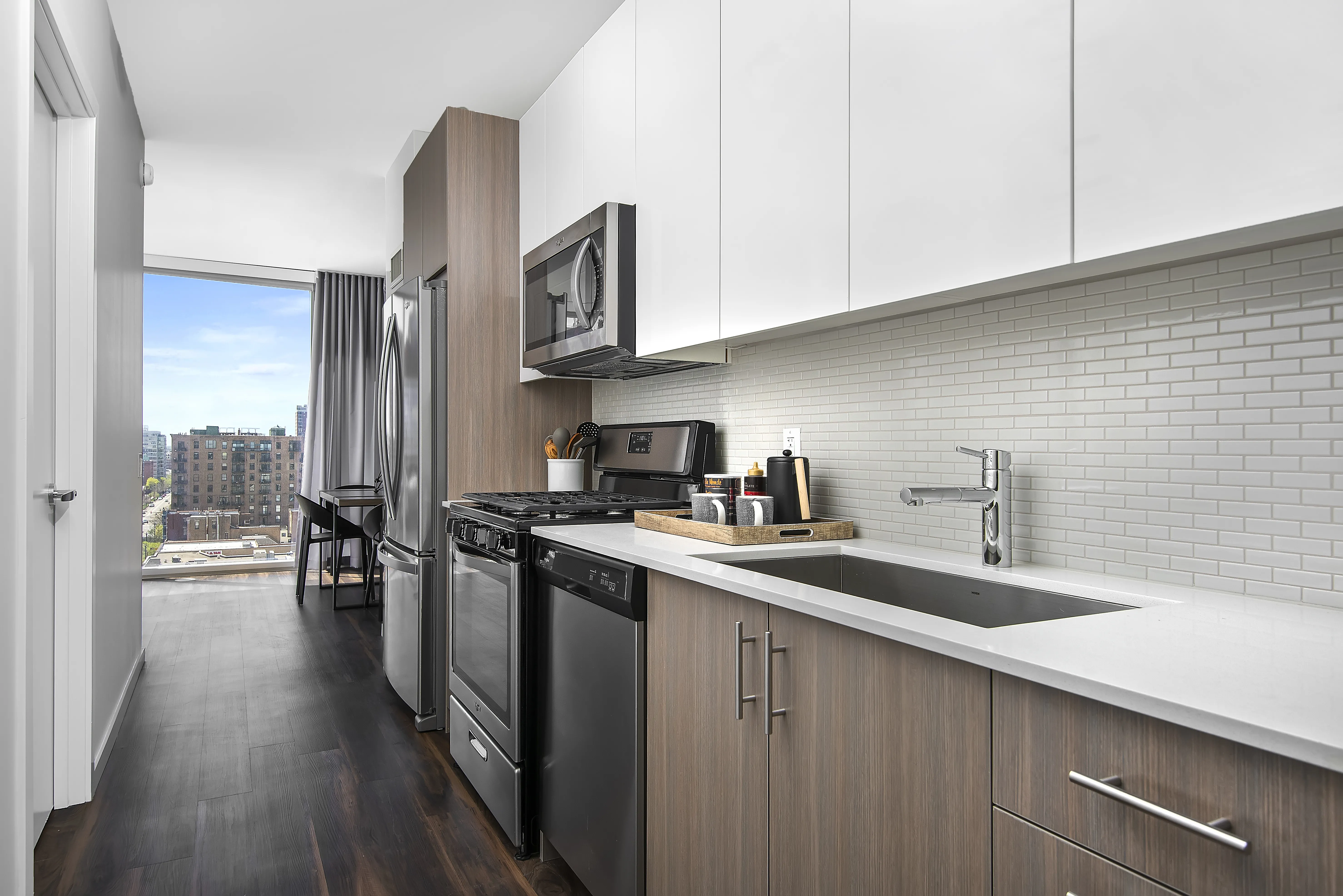 kitchen island, living area and view of the lake at Eleven40 Apartments