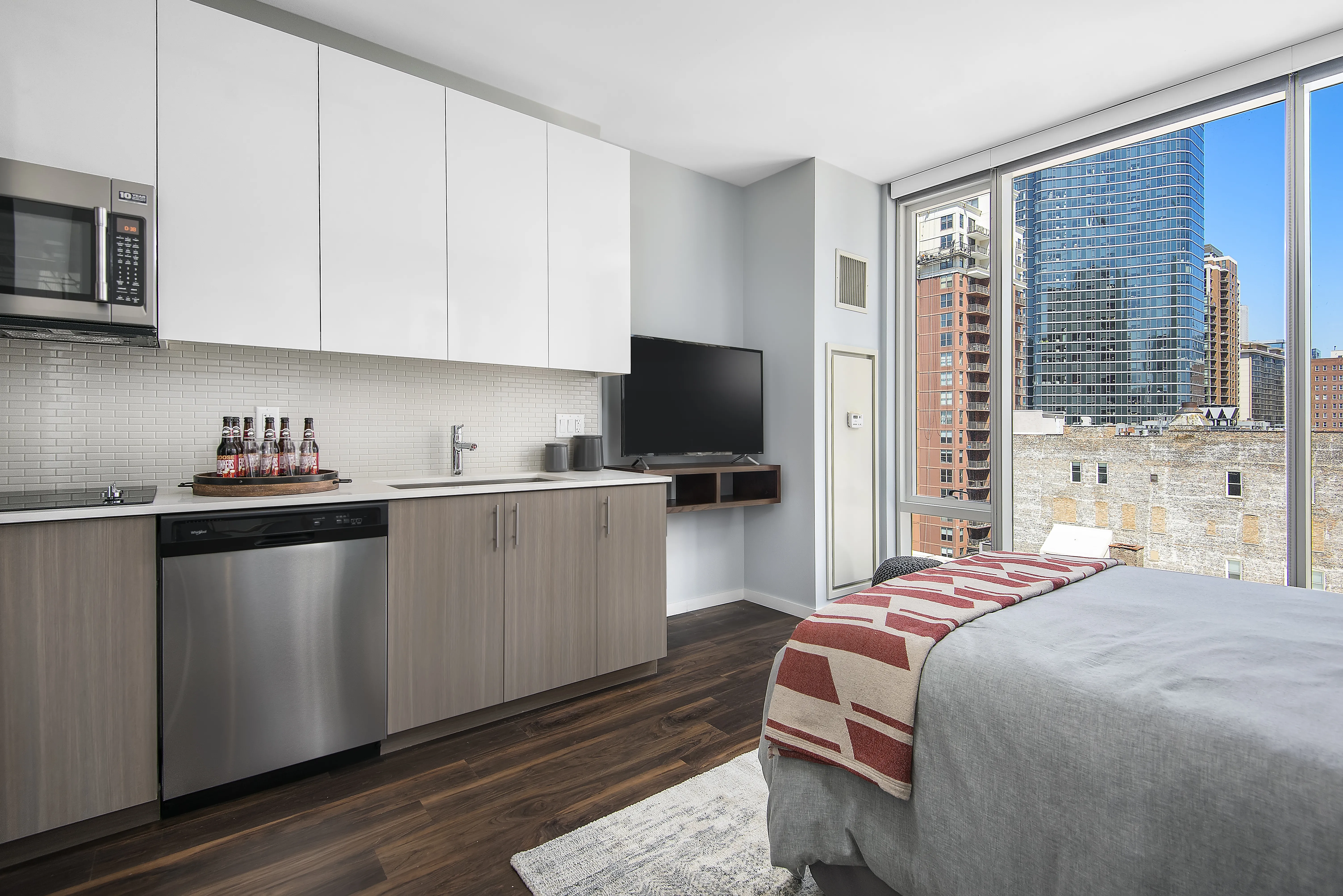 kitchen island, living area and view of the lake at Eleven40 Apartments