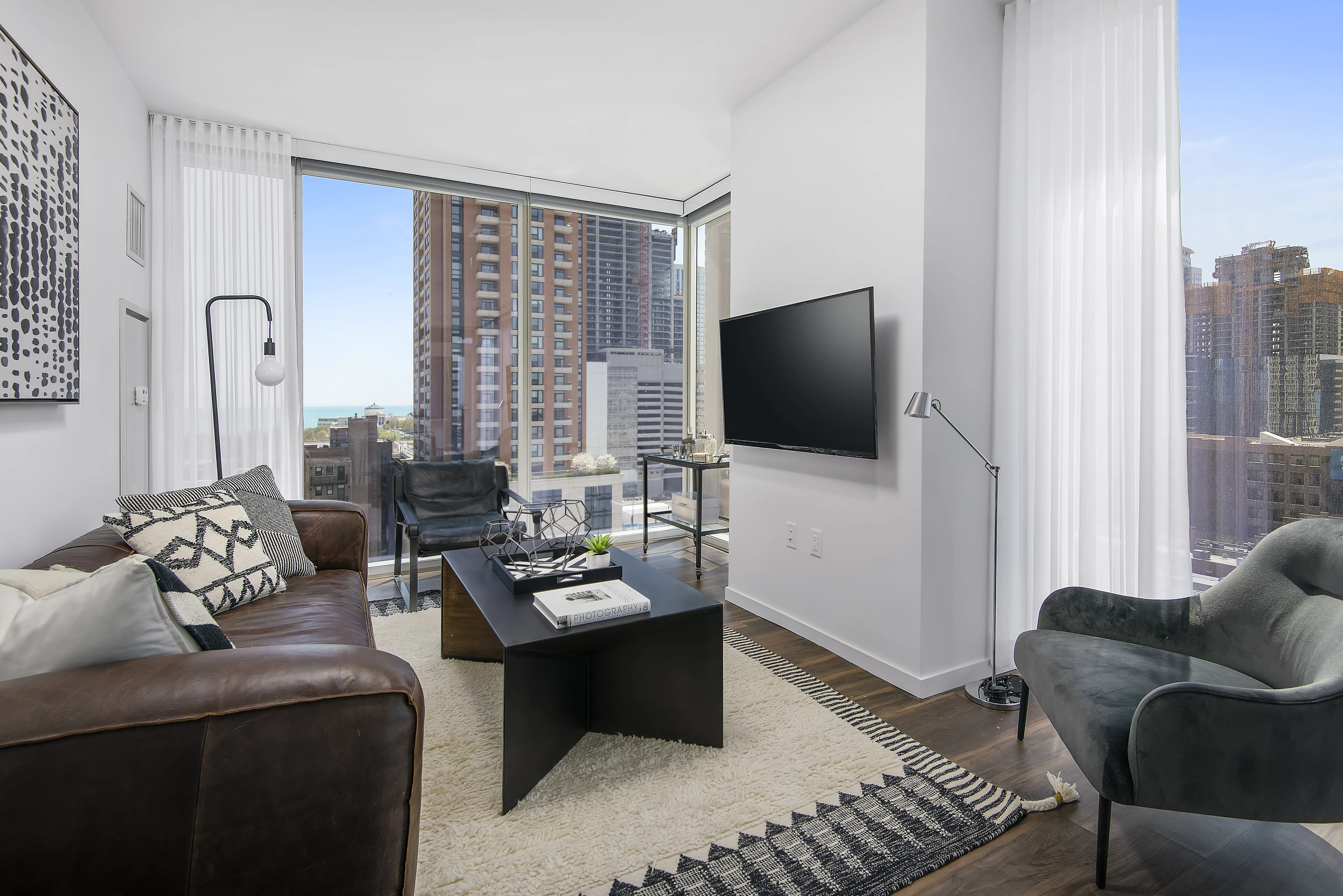kitchen island, living area and view of the lake at Eleven40 Apartments