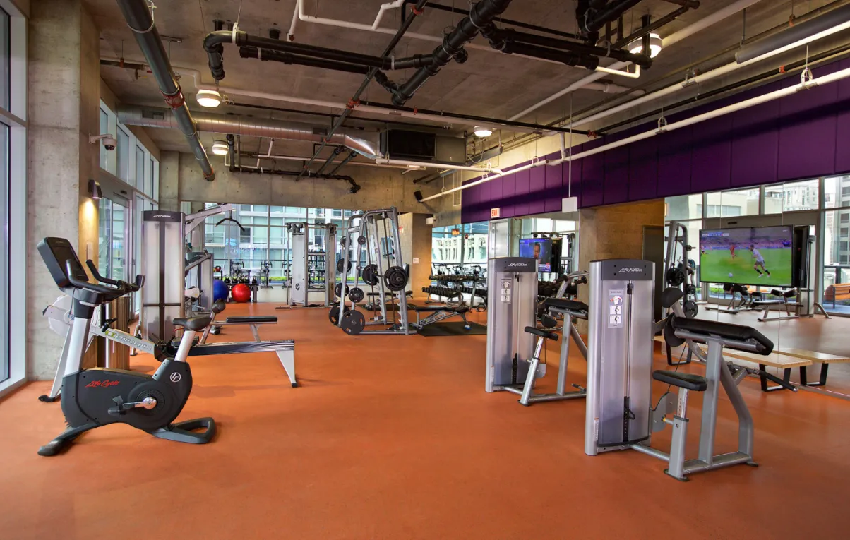 living room with wood floors and downtown view at Aston Chicago Apartments