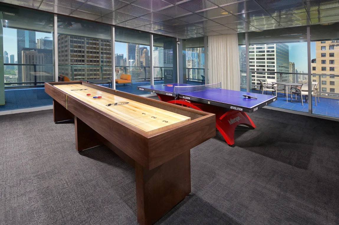 living room with wood floors and downtown view at Aston Chicago Apartments