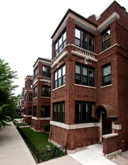 sidewalk view of red brick experior of 2319 North Kedzie Apartments