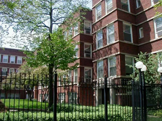 tress and grass in exterior courtyard of The Brittany Apartments