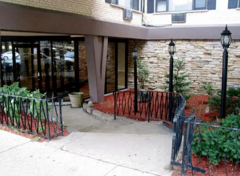 exterior of Sheridan Terrace Apartments with trees in front