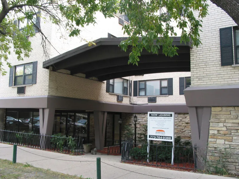 exterior of Sheridan Terrace Apartments with trees in front