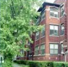 trees and red brick exterior of Crossroads of East Ravenswood Apartments