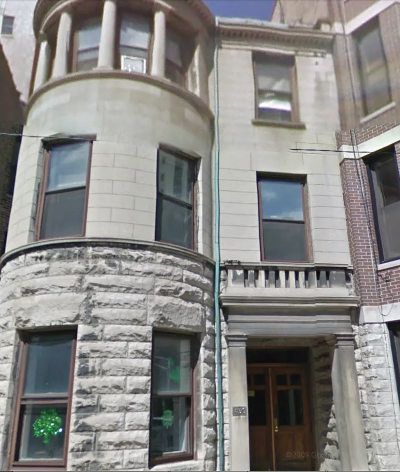 graystone facade of three story 450 W St James Place Apartments
