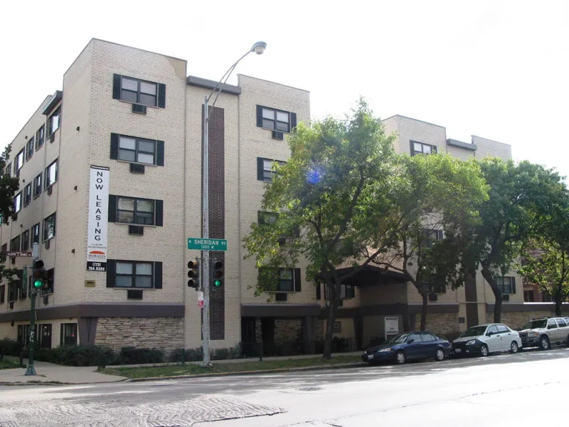 exterior of Sheridan Terrace Apartments with trees in front