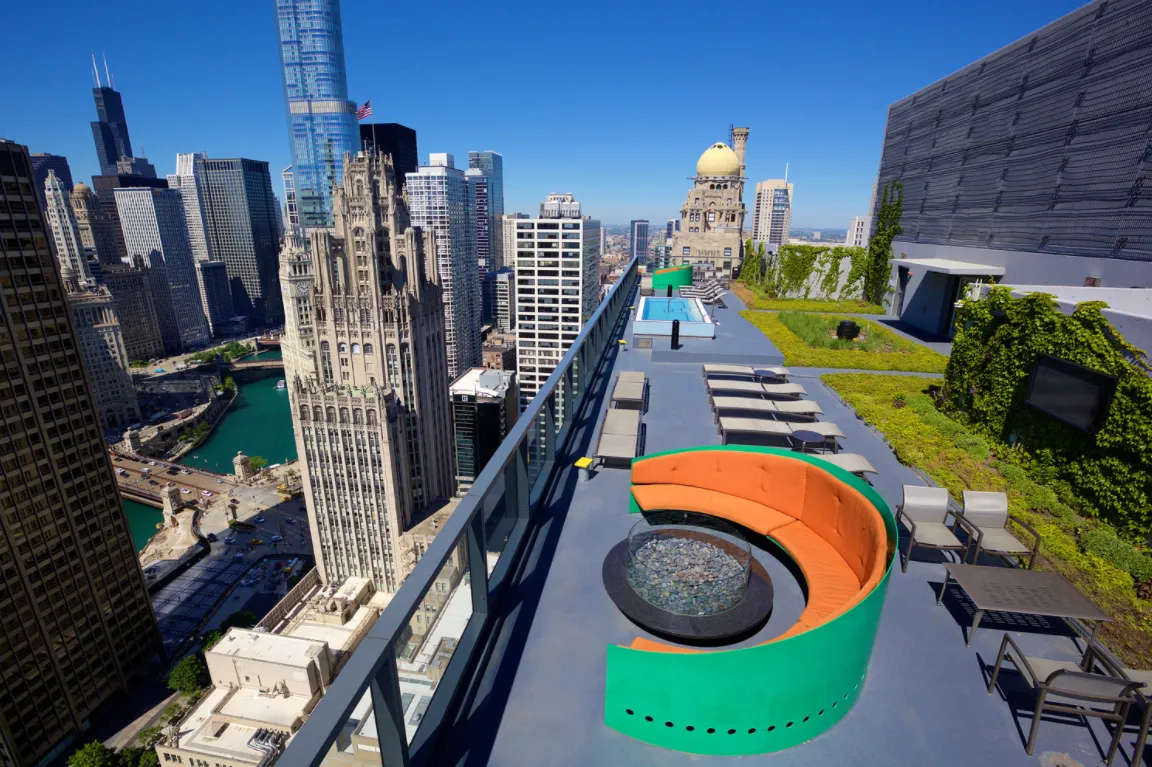 living room with wood floors and downtown view at Aston Chicago Apartments