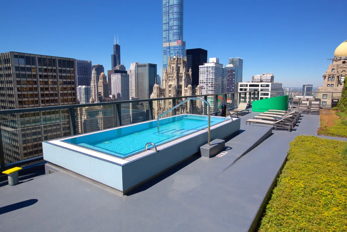 living room with wood floors and downtown view at Aston Chicago Apartments