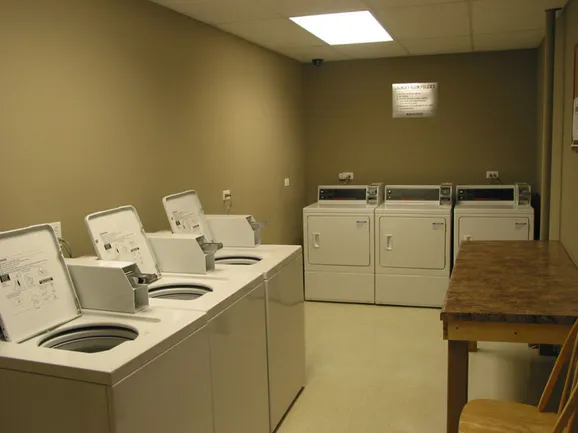 exterior of Sheridan Terrace Apartments with trees in front