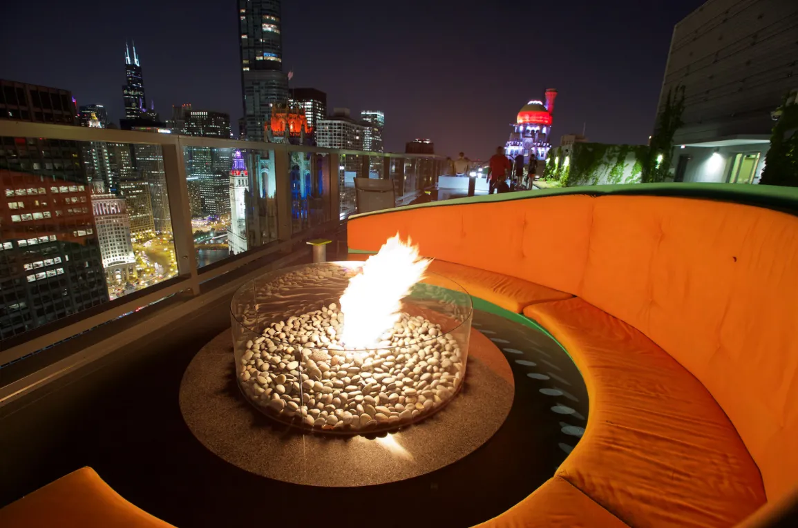 living room with wood floors and downtown view at Aston Chicago Apartments