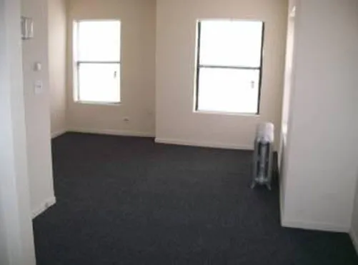 tan brick street exterior and entrance of 4737 South Ingleside Apartments