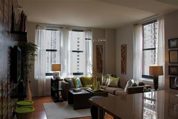 entrance to MDA City Club Apartments with red bench a flowers in pot