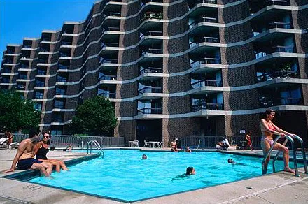 outdoor pool and building exterior at Atrium at Old Town Park Apartments