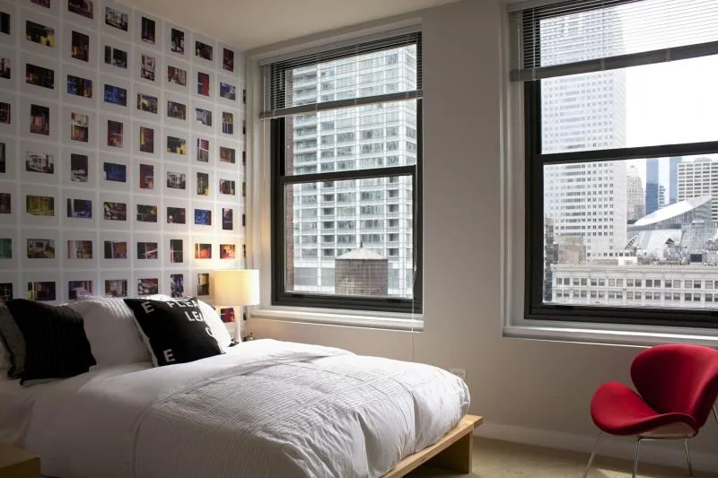 entrance to MDA City Club Apartments with red bench a flowers in pot
