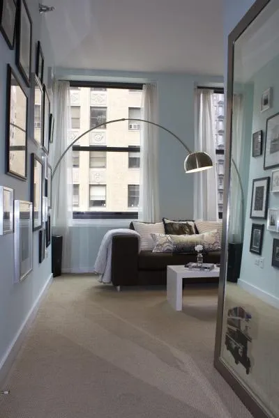 entrance to MDA City Club Apartments with red bench a flowers in pot
