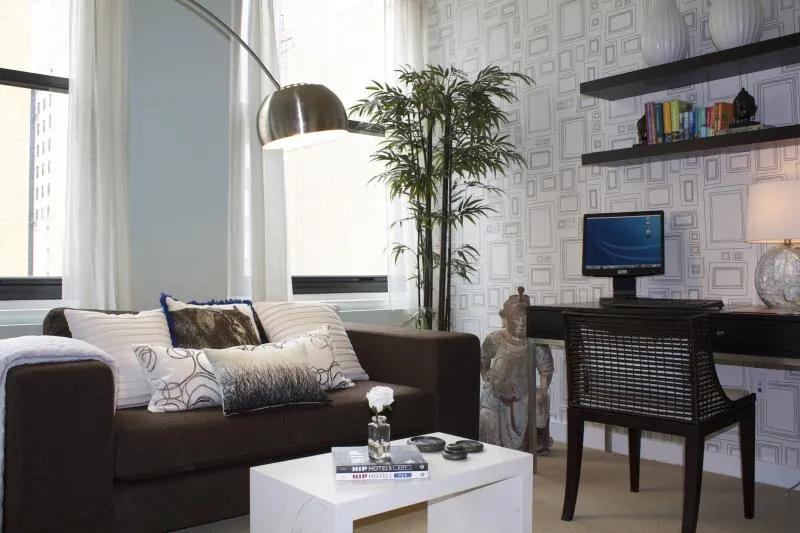 entrance to MDA City Club Apartments with red bench a flowers in pot