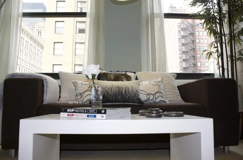 entrance to MDA City Club Apartments with red bench a flowers in pot