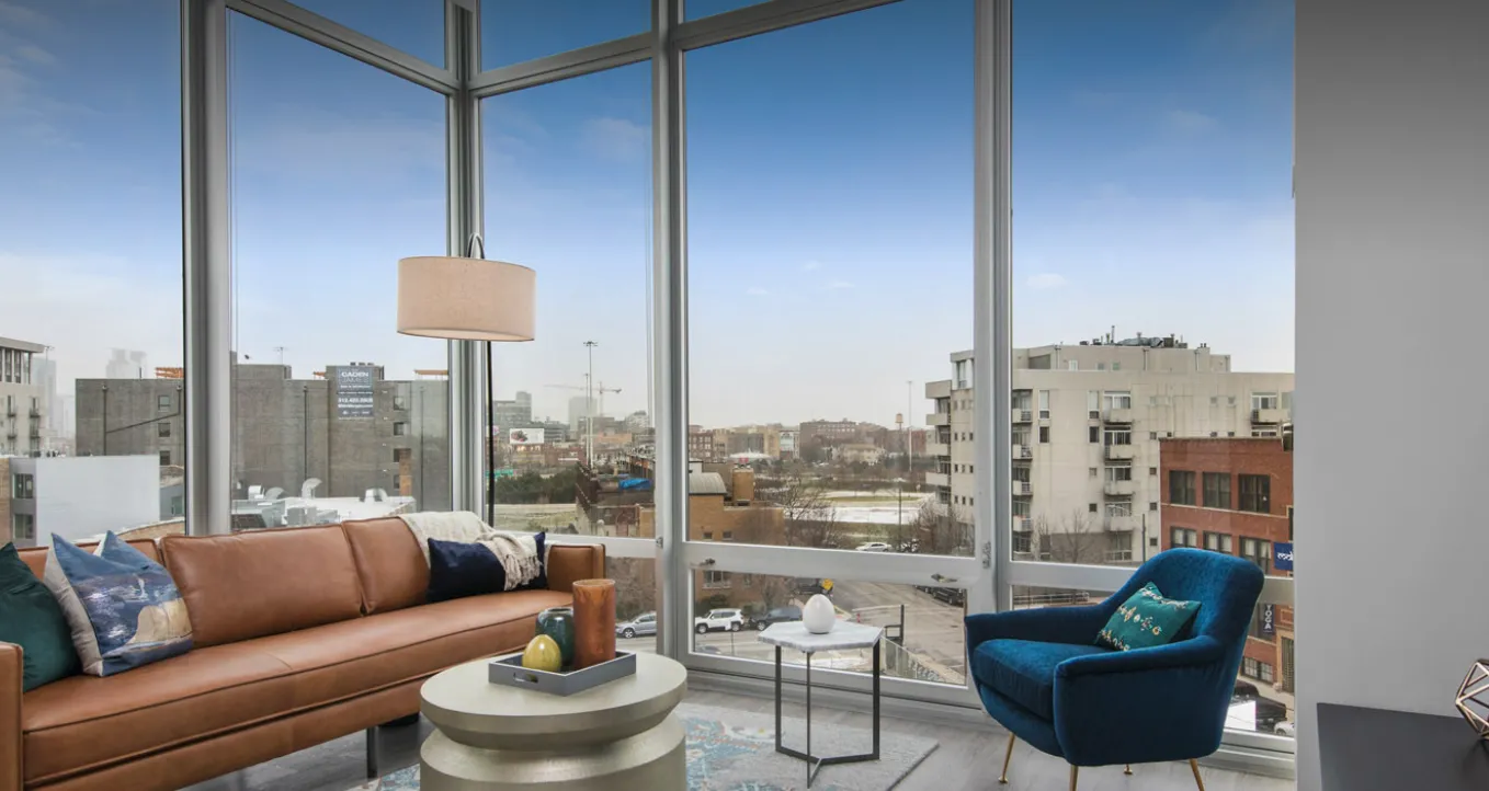 loft like model living room with view of skyline at Spoke Apartments