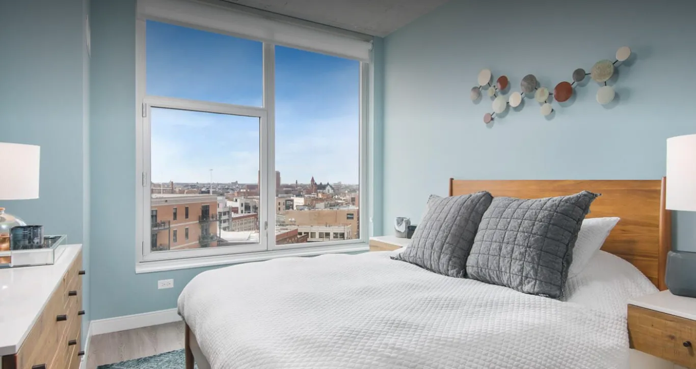 loft like model living room with view of skyline at Spoke Apartments
